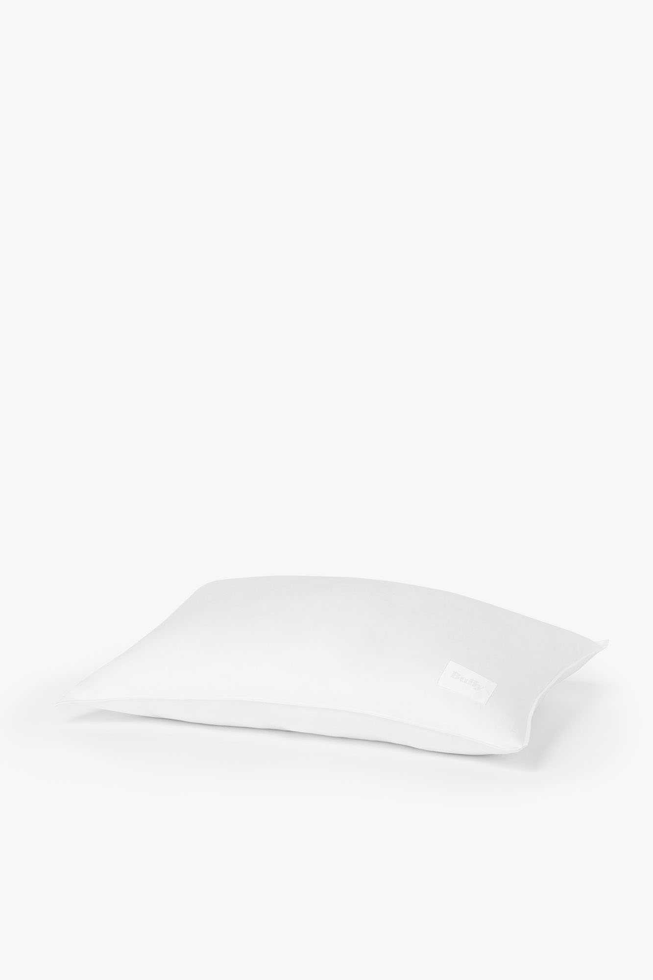 Product shot of a white pillow against a white background.